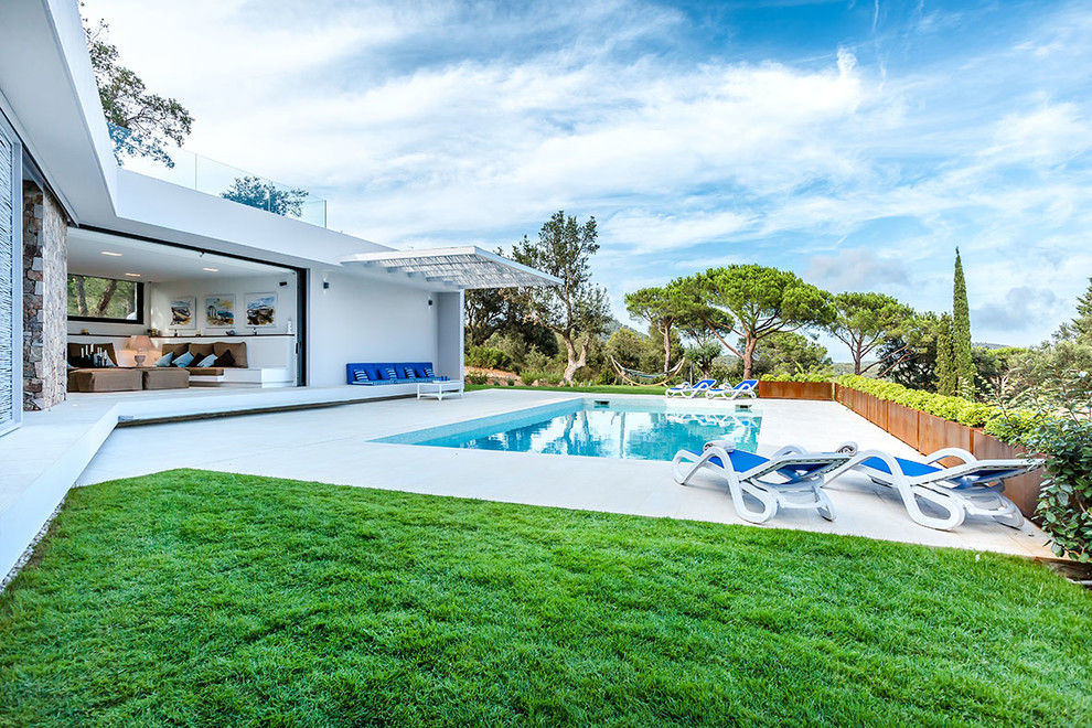 Foto de piscina alargada mediterránea de tamaño medio rectangular en patio trasero
