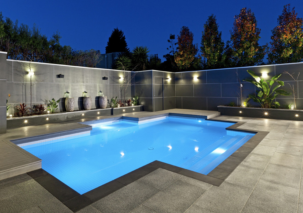 Medium sized contemporary custom shaped lengths swimming pool in Madrid.