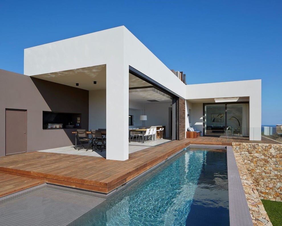 Inspiration for a small modern front l-shaped lengths swimming pool in Other with a pool house.