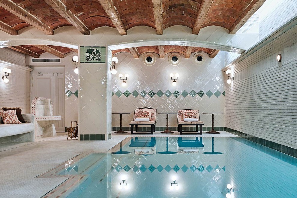 Inspiration for a medium sized world-inspired indoor rectangular lengths swimming pool in Barcelona with a pool house.