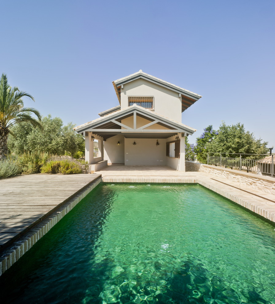 Diseño de casa de la piscina y piscina alargada campestre de tamaño medio rectangular con entablado
