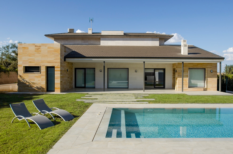 Idee per una piscina monocorsia design rettangolare dietro casa con piastrelle