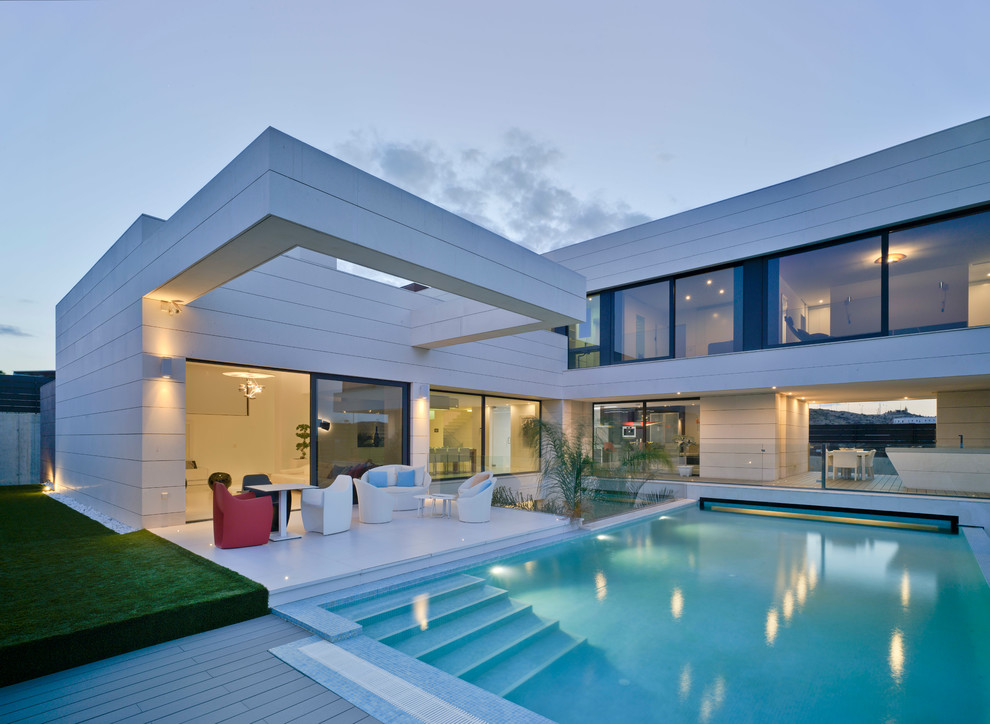 Inspiration for a large modern courtyard rectangular lengths swimming pool in Other with a pool house.