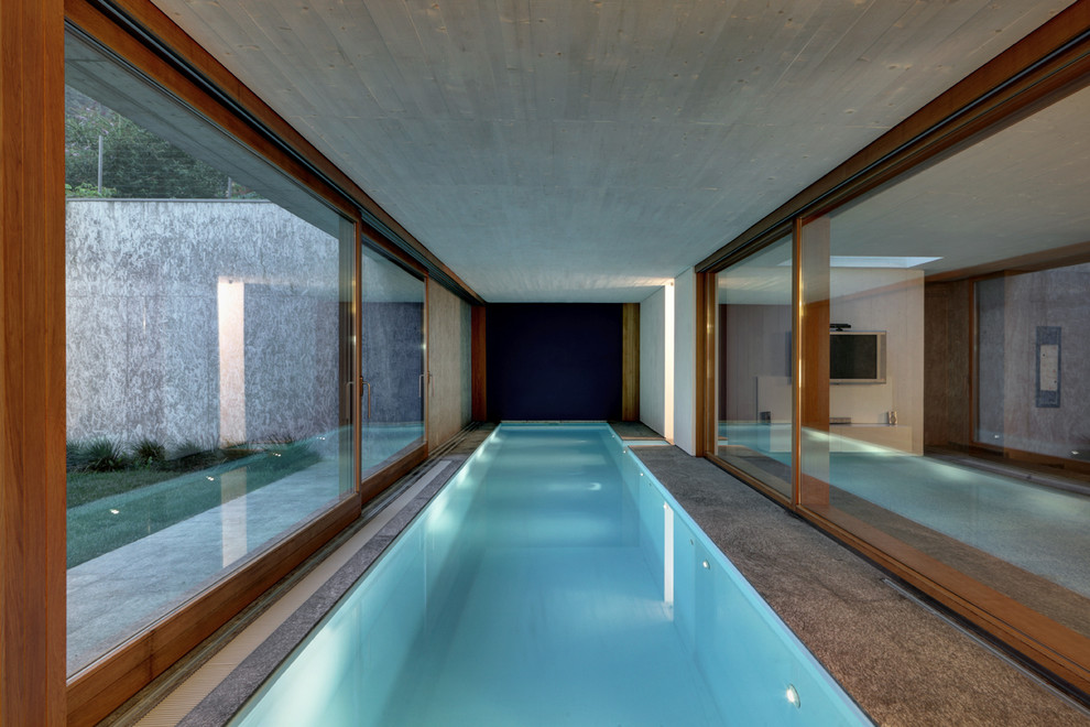 Large trendy indoor rectangular lap pool photo in Milan