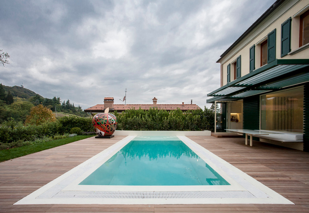 Exemple d'une piscine arrière tendance avec une terrasse en bois.