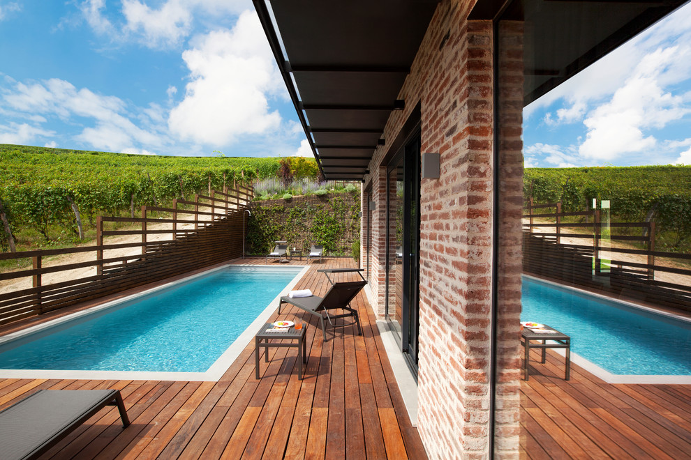 Réalisation d'un couloir de nage arrière champêtre rectangle avec une terrasse en bois.