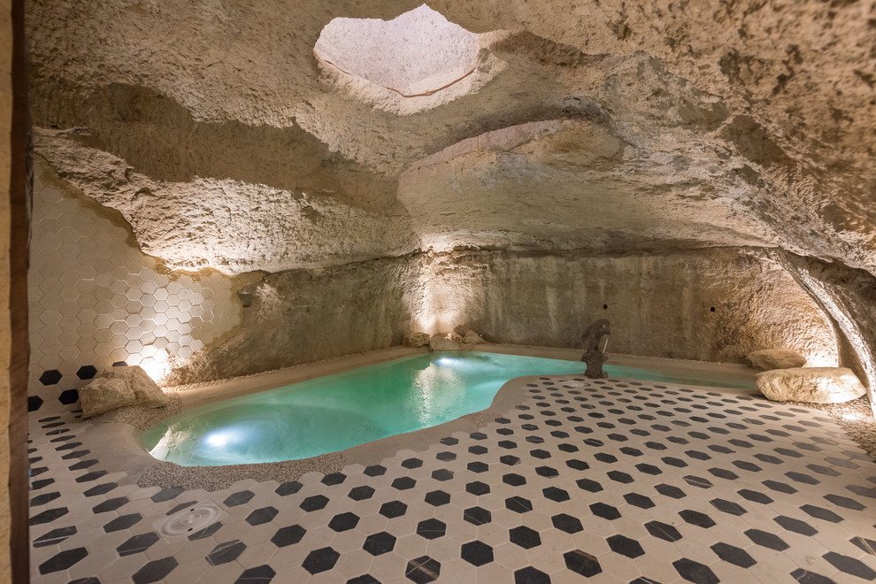 Design ideas for a small mediterranean indoor custom shaped natural swimming pool in Other with tiled flooring.