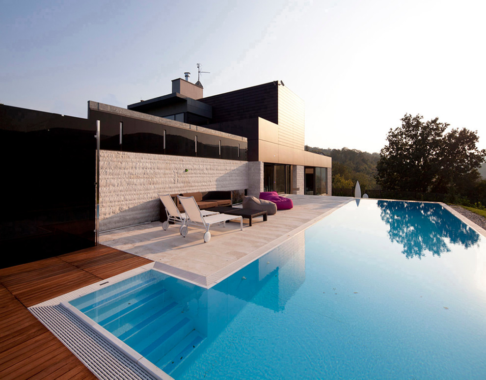 Pool - contemporary rectangular pool idea in Rome with decking