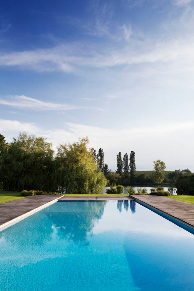 Inspiration for a modern rectangular swimming pool in Milan with decking.