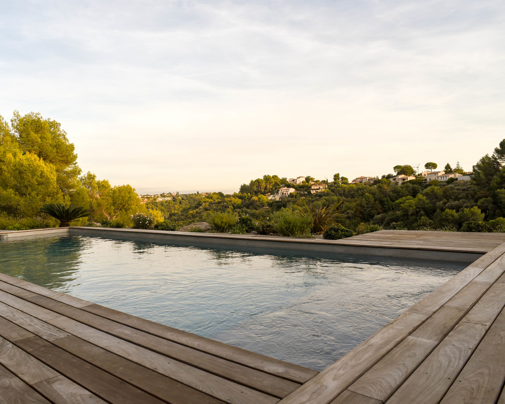 Pool - large mediterranean rectangular lap pool idea in Nice with decking