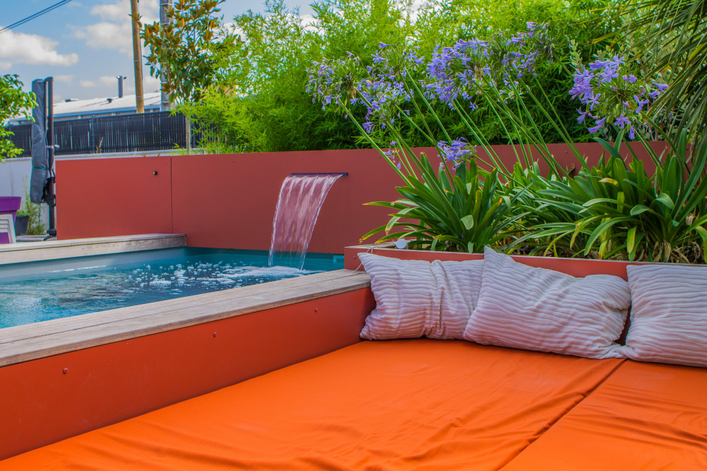 Foto de piscina exótica pequeña rectangular en patio trasero con suelo de baldosas