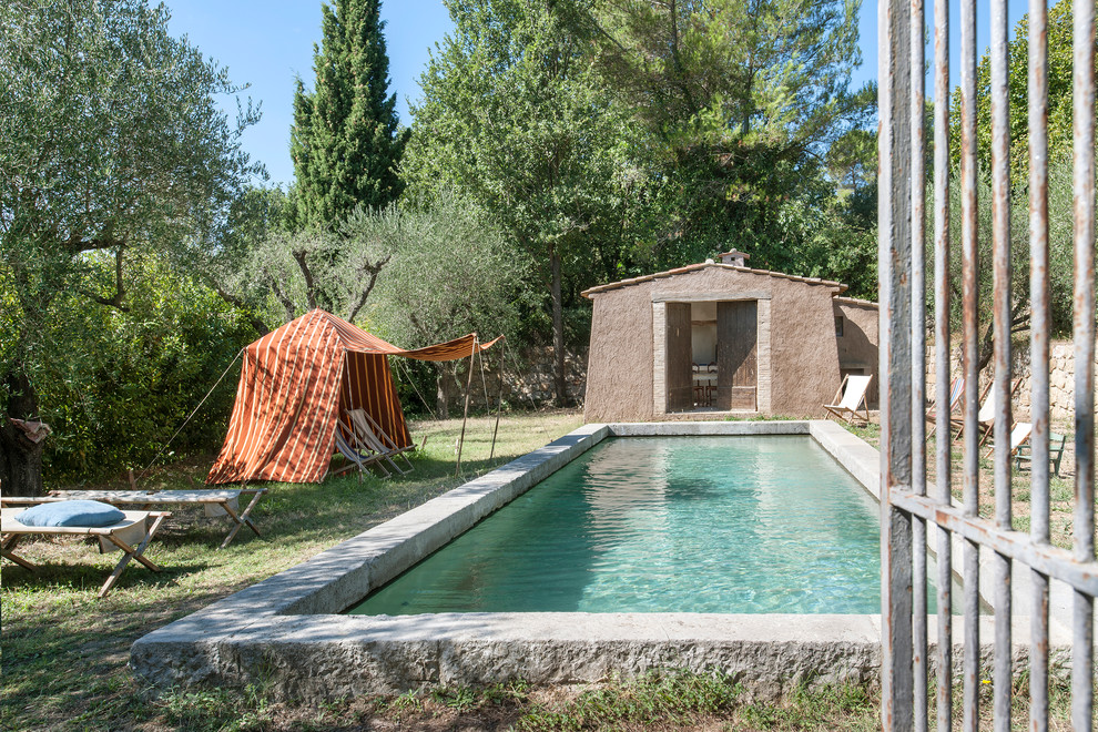 Пример оригинального дизайна: большой прямоугольный бассейн в средиземноморском стиле с домиком у бассейна