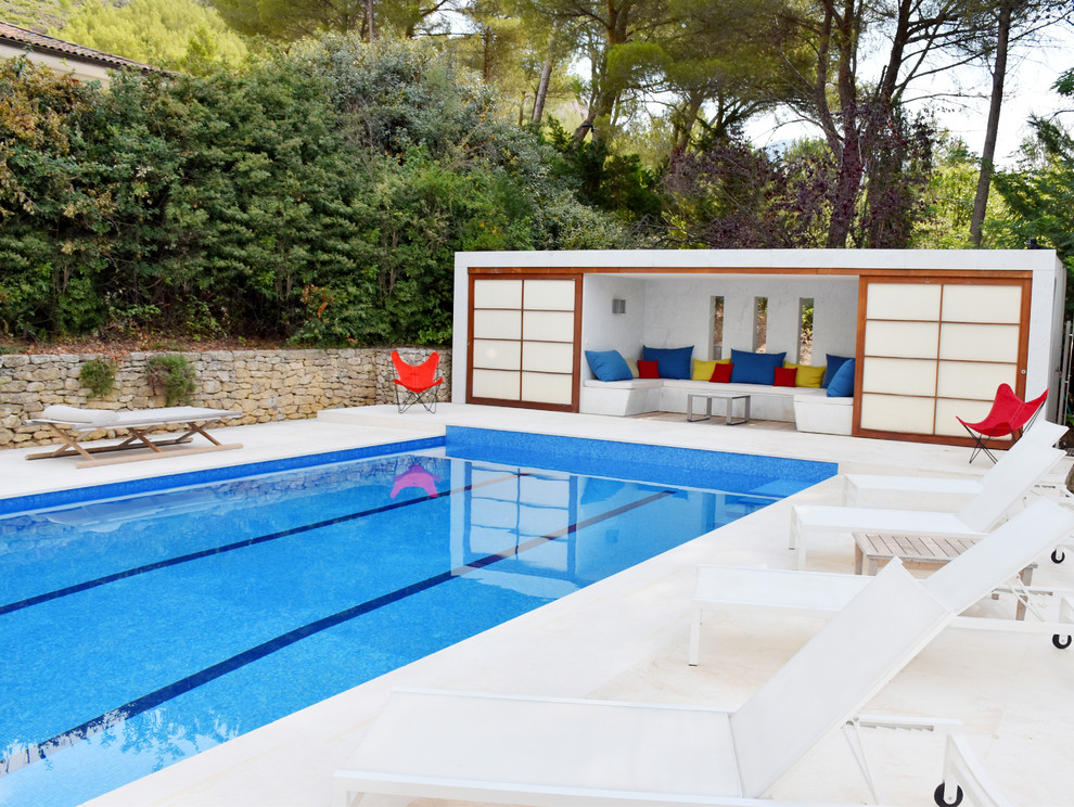 Inspiration for a large contemporary rectangular lengths swimming pool in Marseille with natural stone paving.