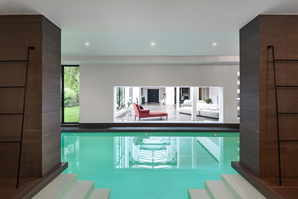 Large contemporary indoor rectangular lengths swimming pool in Paris with tiled flooring.