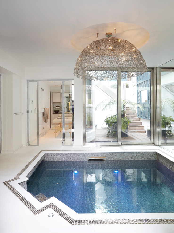 На фото: бассейн произвольной формы в доме в современном стиле с покрытием из плитки с