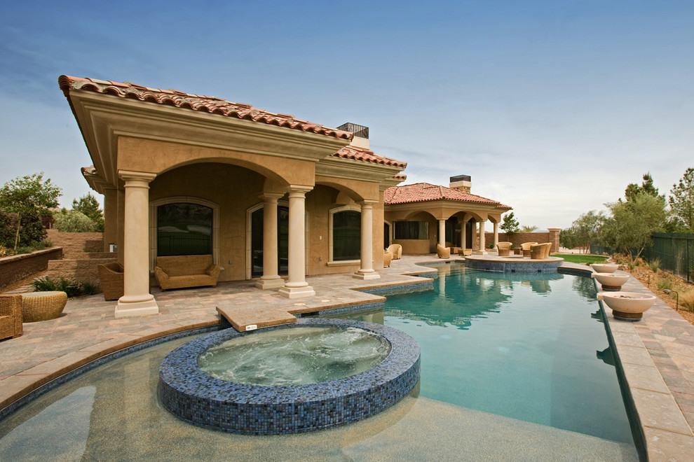 Large tuscan custom-shaped pool photo in Las Vegas
