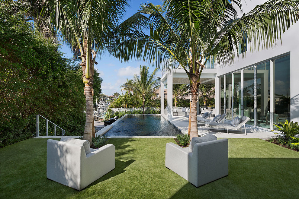 Idee per una piscina a sfioro infinito stile marinaro rettangolare di medie dimensioni e dietro casa con cemento stampato