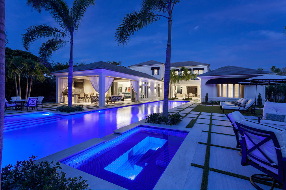 Pool - huge coastal backyard stone and rectangular lap pool idea in Miami
