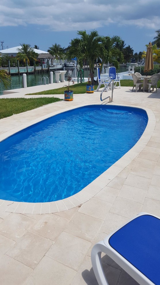 Pool - small traditional backyard concrete paver and custom-shaped natural pool idea in Miami