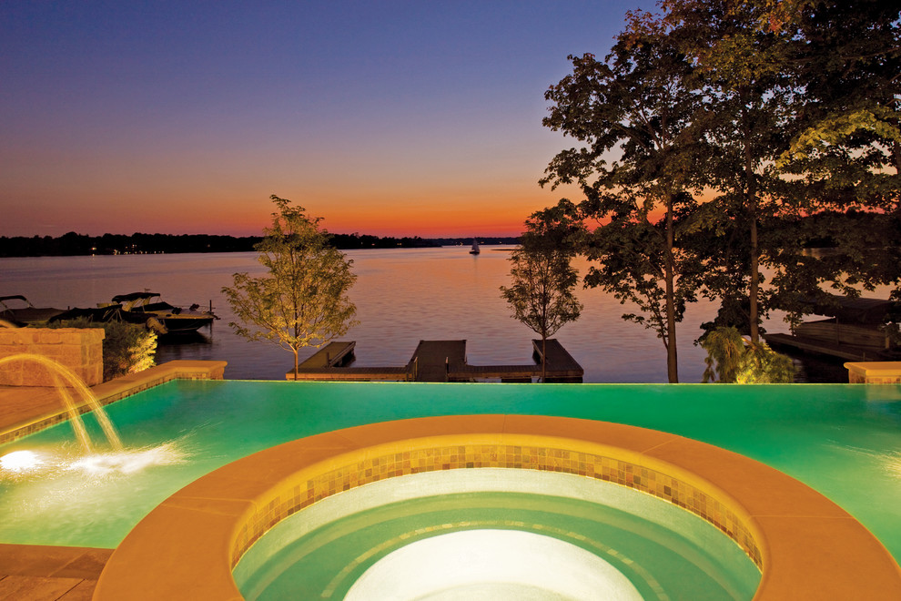 Mid-sized tuscan backyard rectangular infinity pool fountain photo in Indianapolis