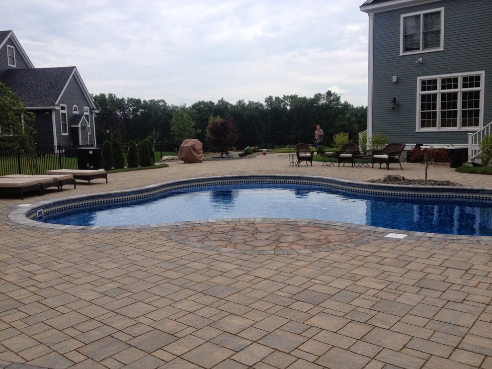 Inspiration for a huge timeless backyard concrete paver and custom-shaped pool remodel in Boston