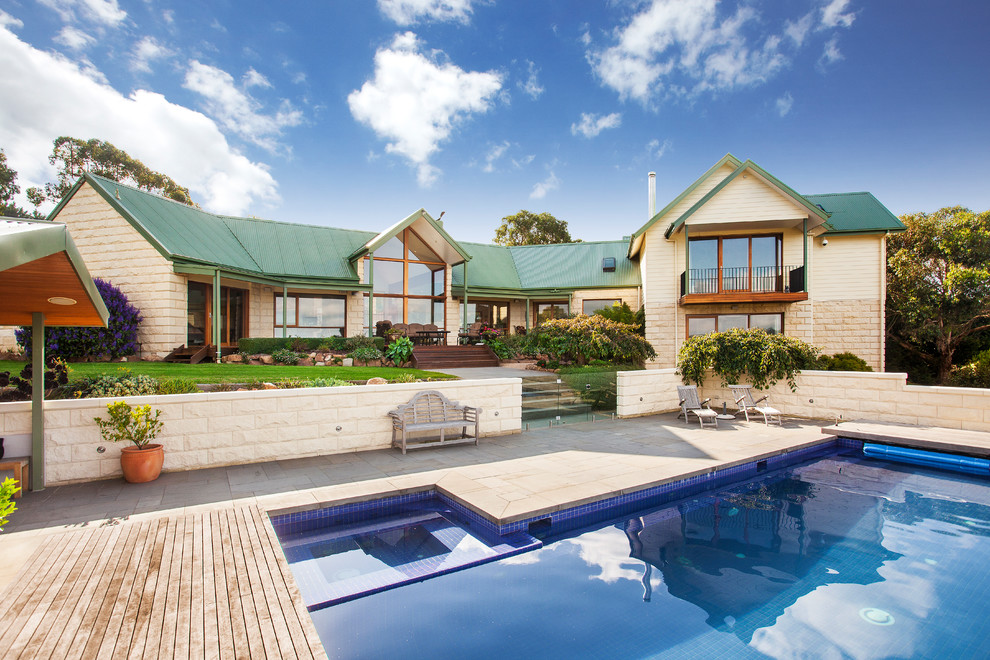 Elegant backyard stone and rectangular lap pool photo in Melbourne