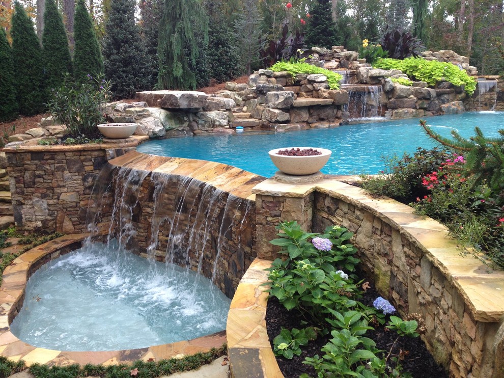 Pool - huge tropical backyard infinity pool idea in Atlanta