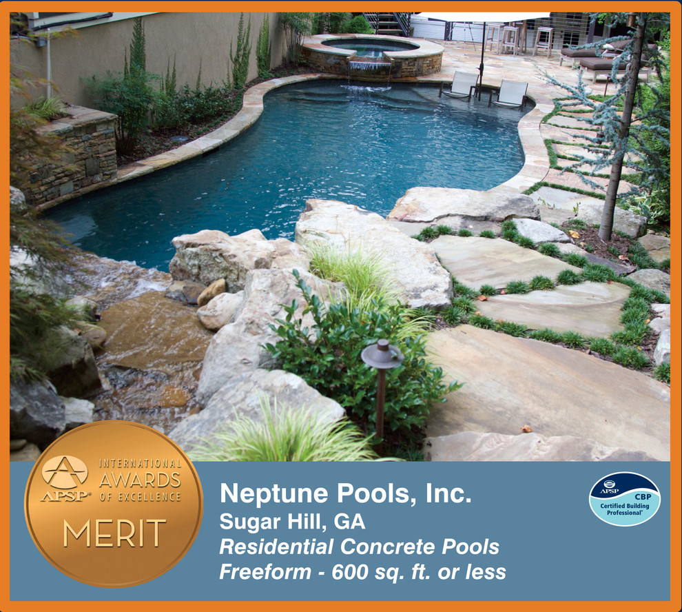 Pool fountain - contemporary backyard stone and custom-shaped natural pool fountain idea in Atlanta