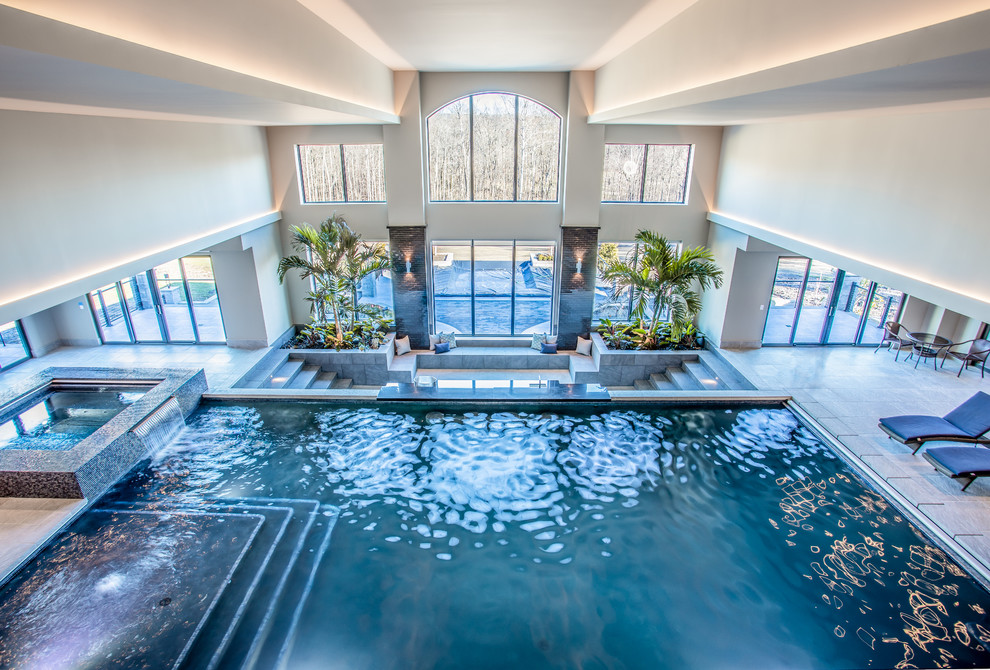 Foto di una grande piscina coperta monocorsia classica rettangolare con una vasca idromassaggio e piastrelle
