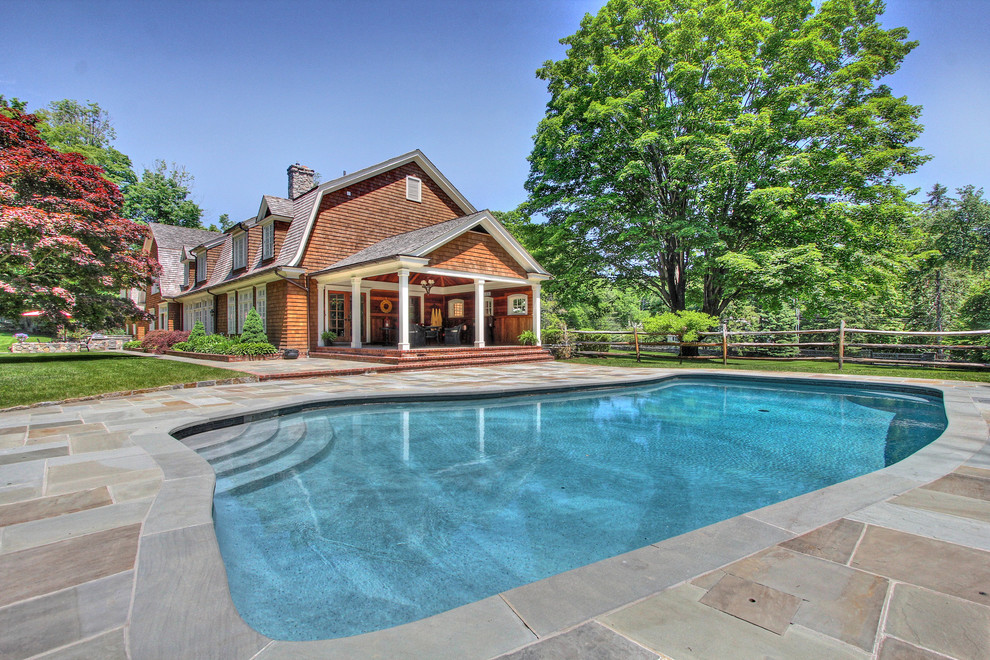 Inspiration for a large classic side custom shaped natural swimming pool in Bridgeport.