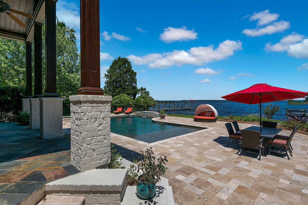 Inspiration for a large timeless backyard stone and custom-shaped hot tub remodel in Jacksonville