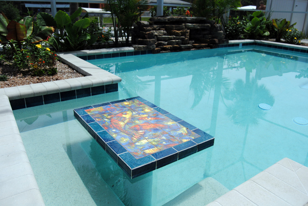 Beach style backyard brick and rectangular lap hot tub photo in Miami