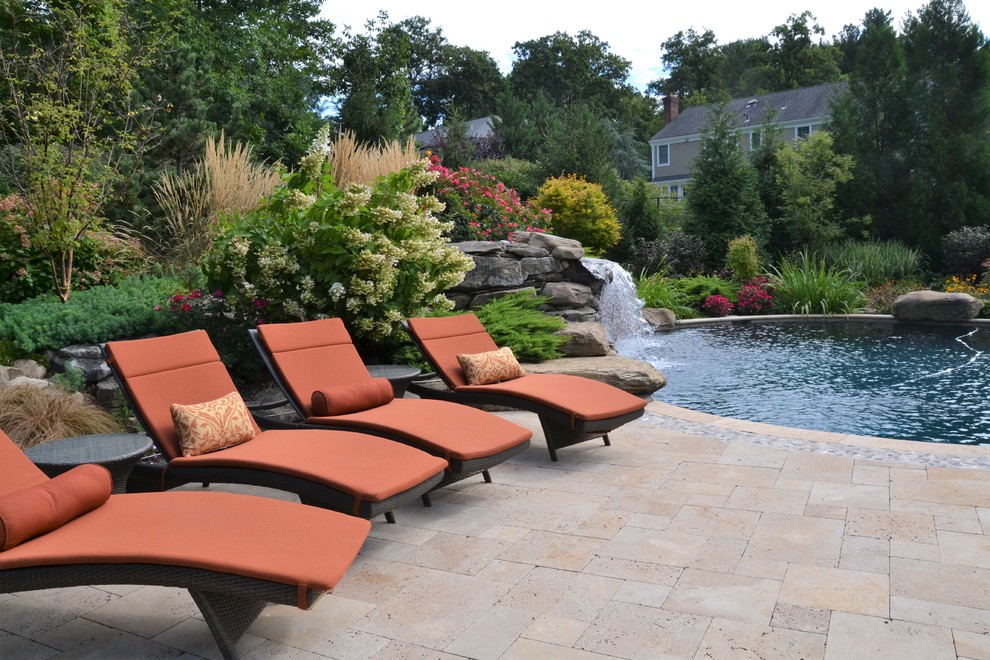 Photo of a large world-inspired back custom shaped swimming pool in New York with a water feature.
