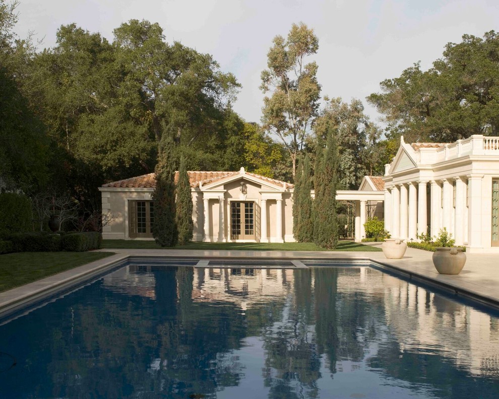 Photo of a large traditional back rectangular above ground swimming pool with concrete paving.