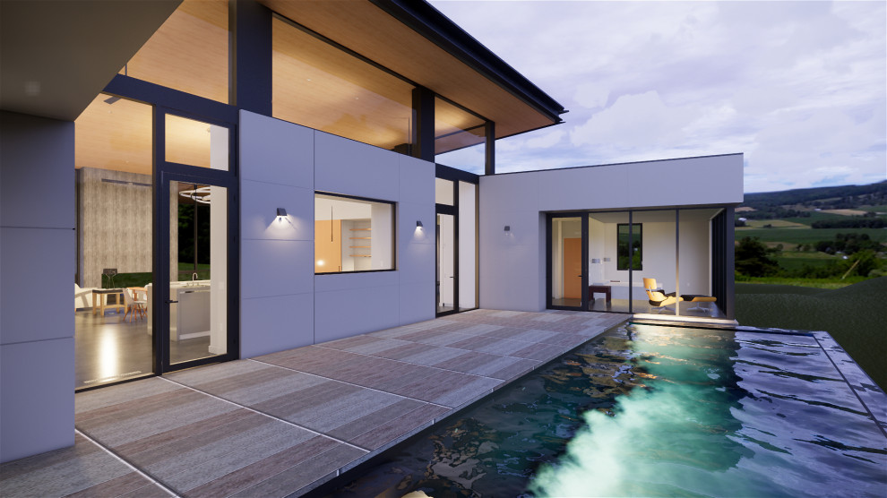 Esempio di una piscina a sfioro infinito minimalista personalizzata di medie dimensioni e in cortile con pedane