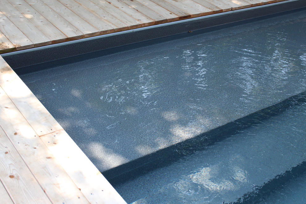 This is an example of a large rustic back l-shaped natural hot tub in Atlanta with decking.