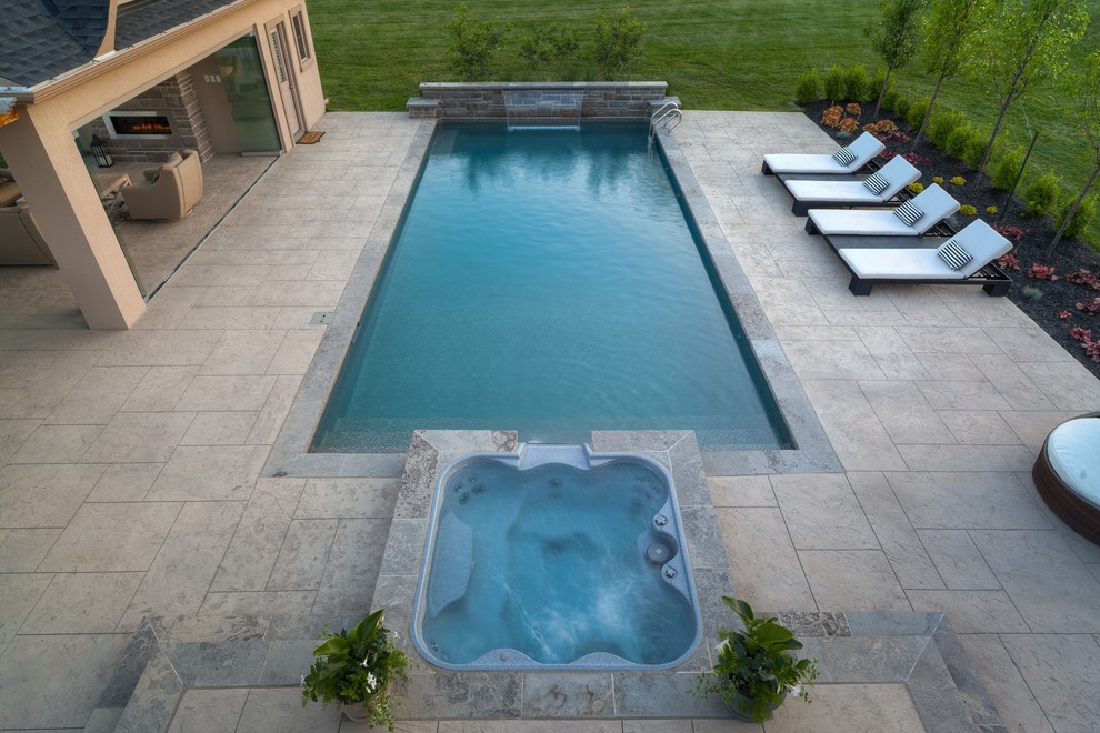 Pool house - mid-sized contemporary backyard stamped concrete and rectangular lap pool house idea in Toronto