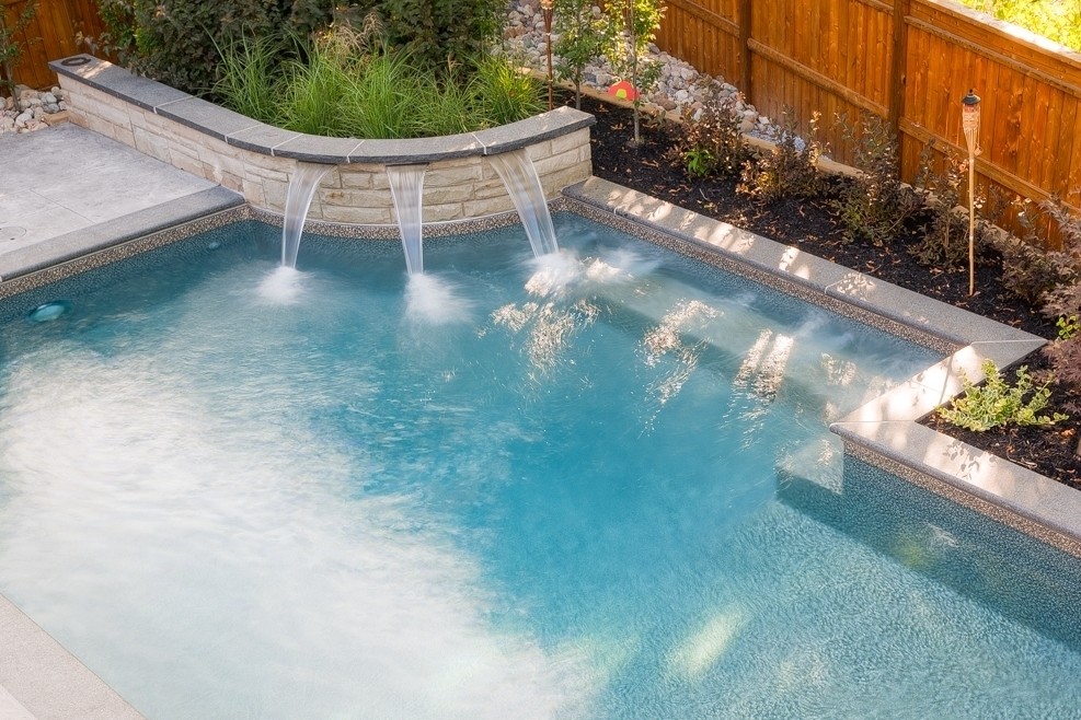 Hot tub - small contemporary backyard stamped concrete and rectangular hot tub idea in Toronto