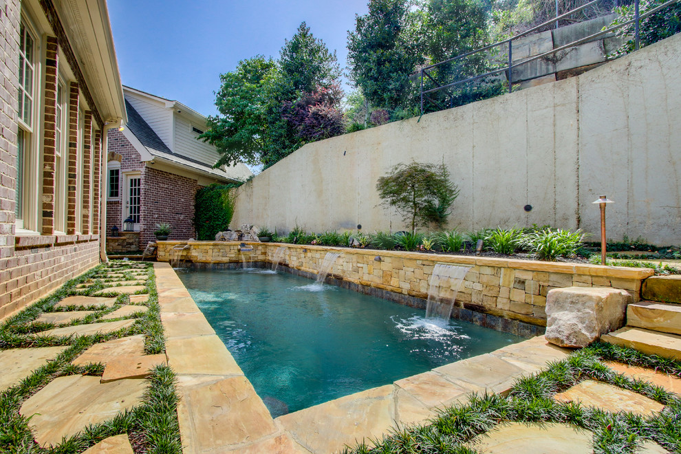 Photo of a medium sized rustic back rectangular lengths hot tub in Atlanta with natural stone paving.