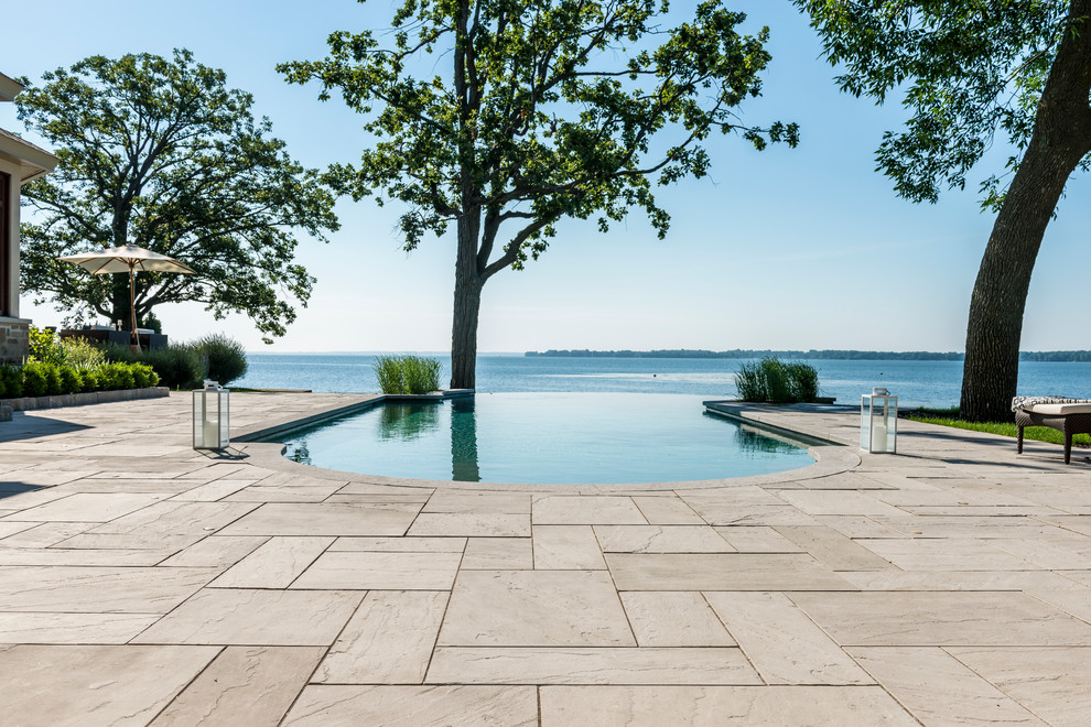 Huge trendy backyard concrete and custom-shaped infinity pool photo in Philadelphia