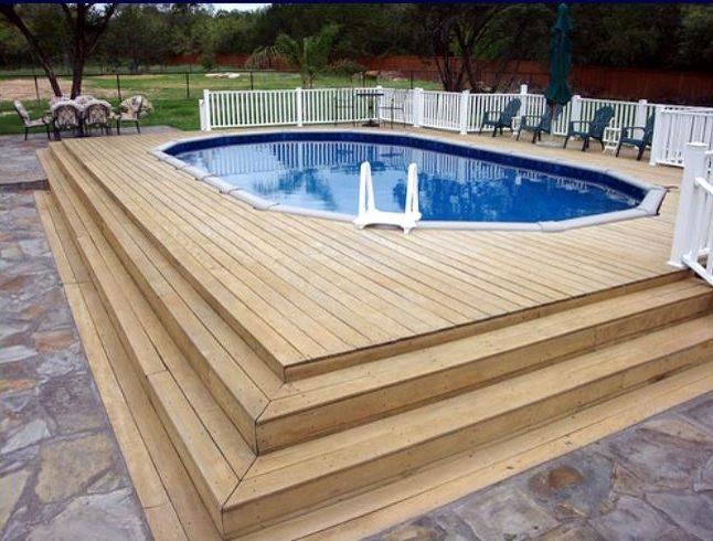 Design ideas for a large traditional back round lengths swimming pool in New York with decking.