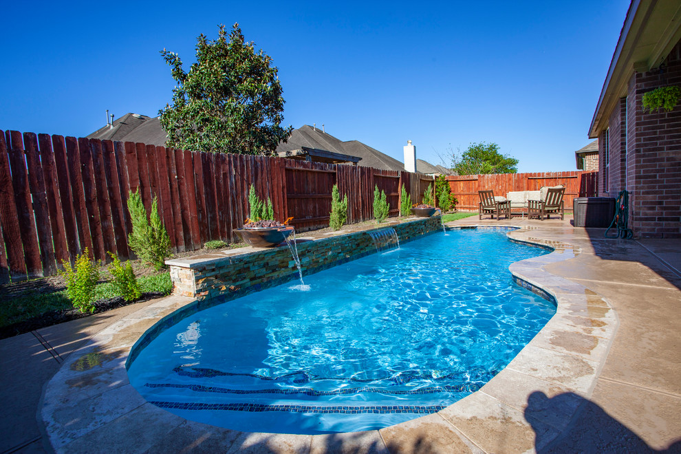 Photo of a small modern back custom shaped swimming pool in Houston with decking.