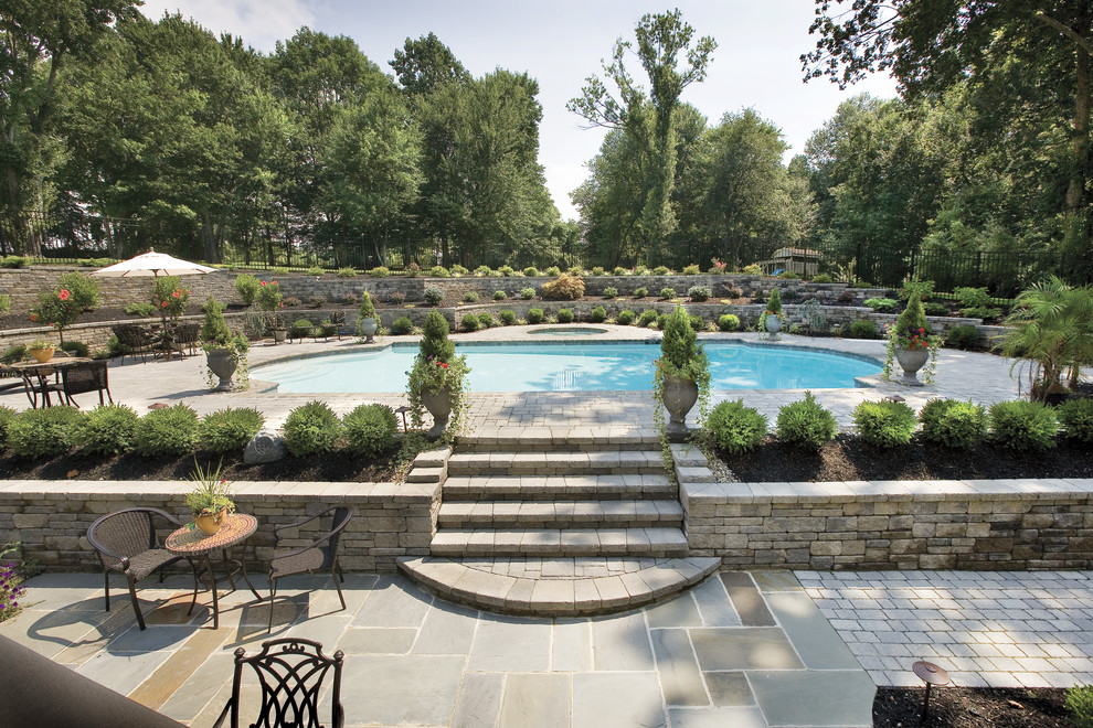 Large elegant backyard concrete paver and rectangular lap hot tub photo in Philadelphia