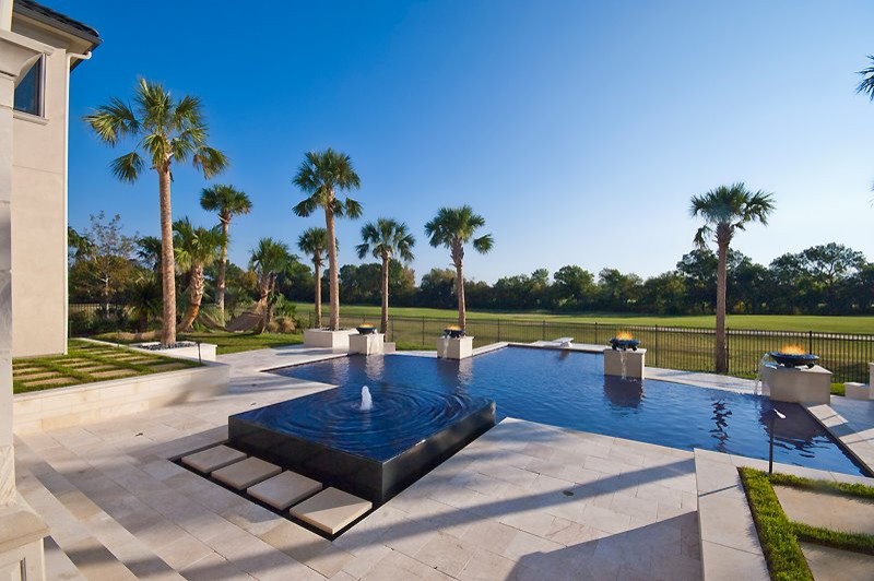 Example of a mid-sized trendy backyard tile and custom-shaped pool fountain design in Dallas