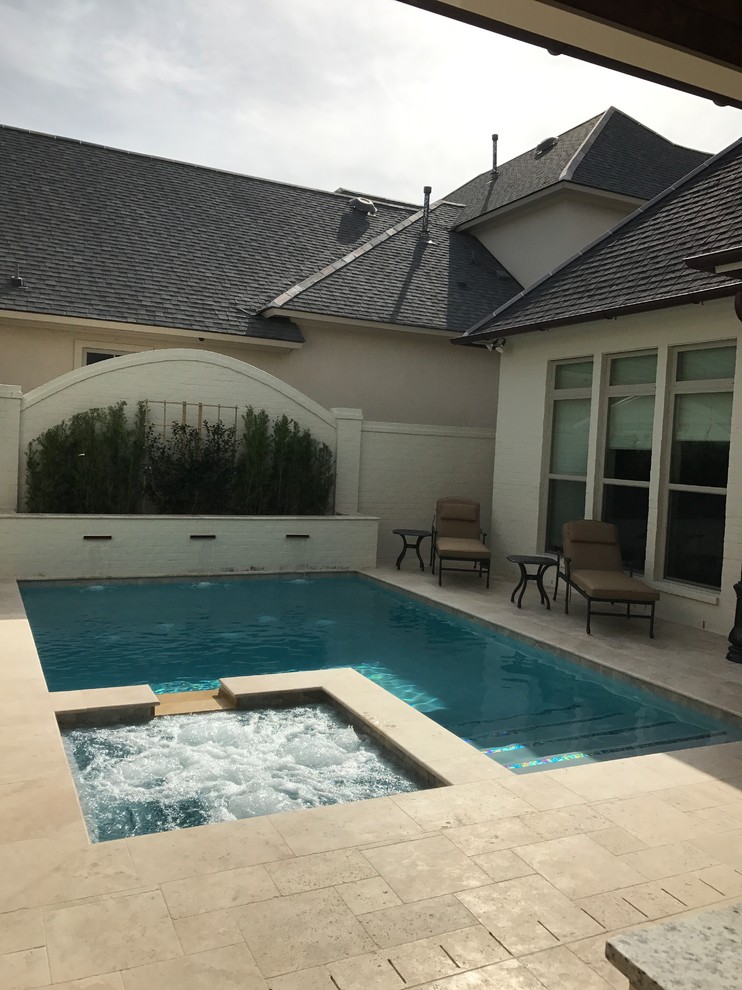 Small elegant courtyard stone and rectangular pool photo in New Orleans