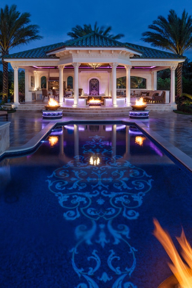 Design ideas for an expansive mediterranean back custom shaped infinity hot tub in Tampa.