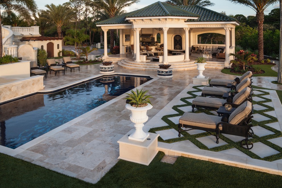 Example of a huge tuscan backyard custom-shaped infinity hot tub design in Tampa