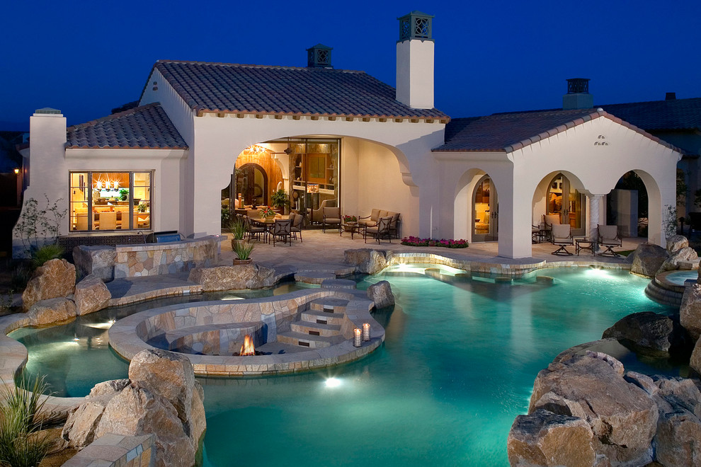 Mediterranean custom shaped swimming pool in Orange County with a bar area.