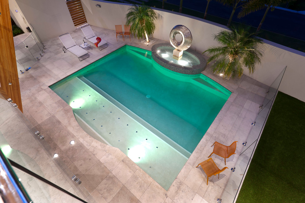 Idee per una grande piscina naturale minimalista rettangolare davanti casa con fontane e piastrelle