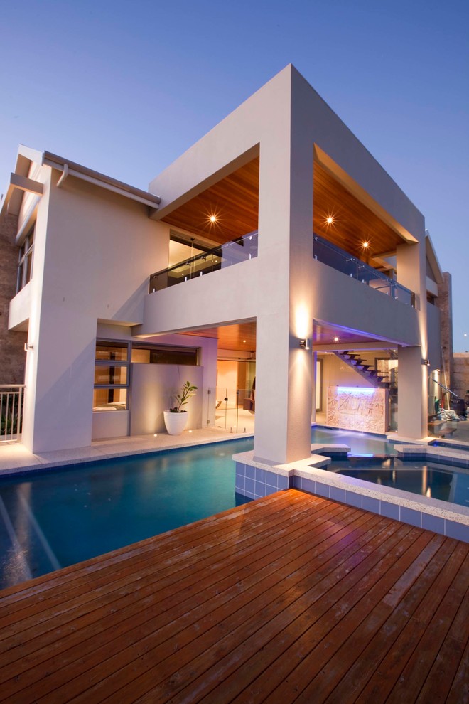 Example of a trendy backyard custom-shaped pool design in Perth with decking